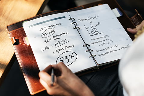 Person Holding Pen in Front of Open Book Planner, activity, analytics HD wallpaper