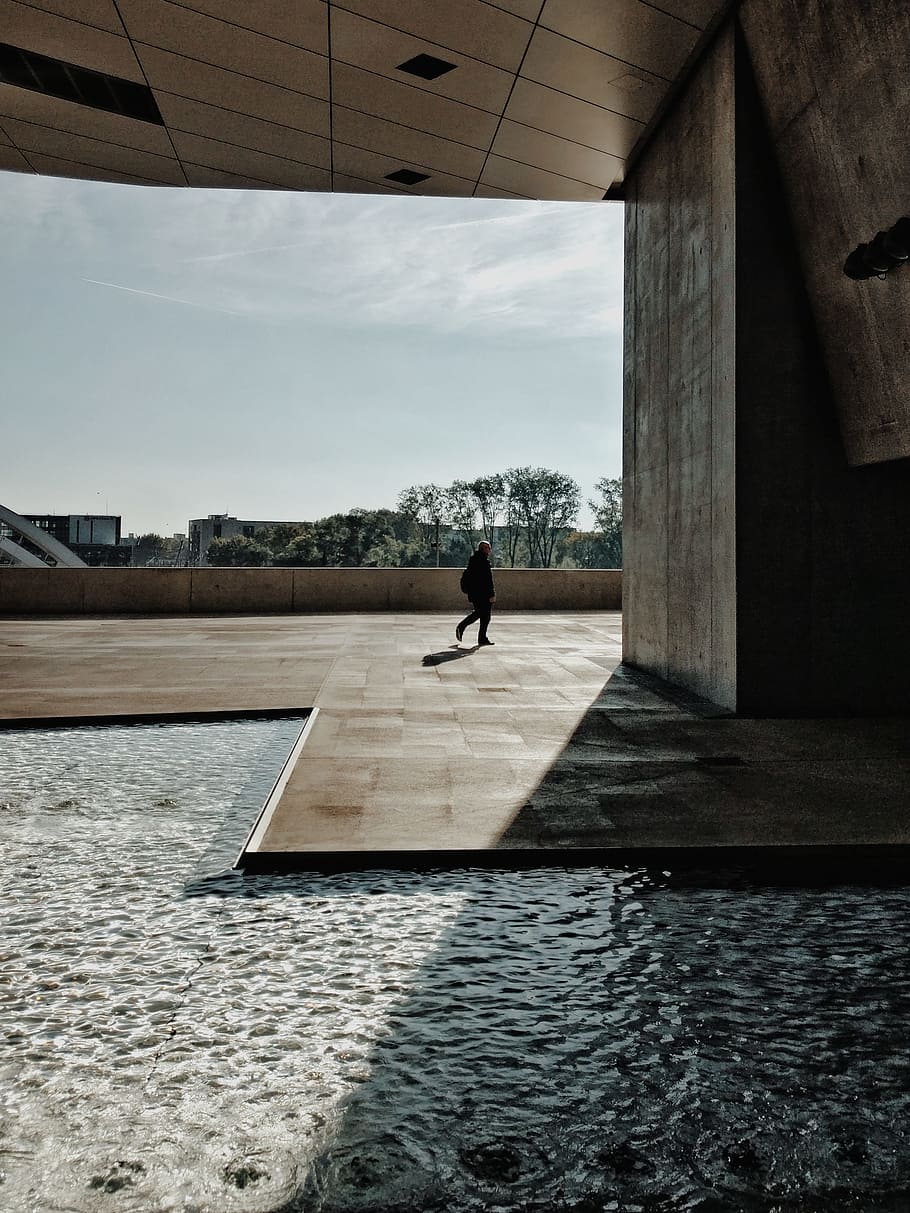 person walks near pillar, light, flow, wallpaper, pattern, shadow HD wallpaper