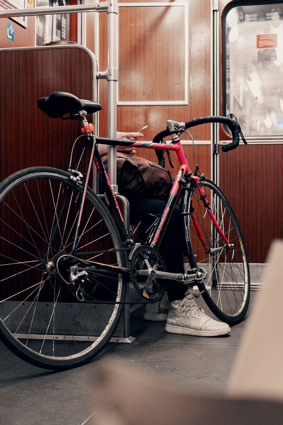 black and red road bike in train, shoe, phone, hand, commute, HD wallpaper