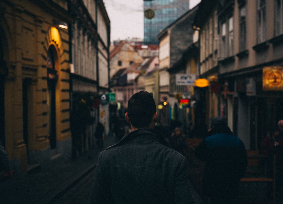 man standing between hallway, city, street, town, person, urban HD wallpaper