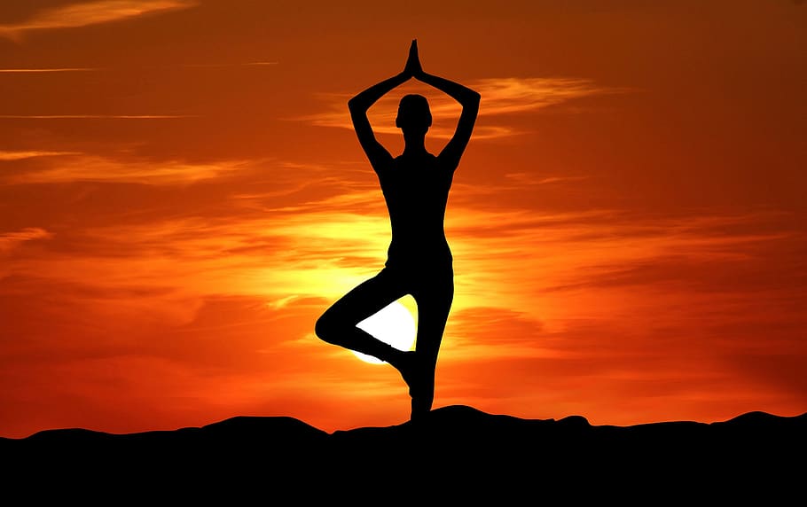 A woman sitting in a lotus position on the beach at sunset Image & Design  ID 0000138052 - SmileTemplates.com