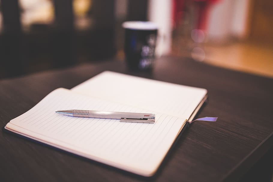 Grey Push Pen on White Notebook, macro, table, still life, focus on foreground HD wallpaper