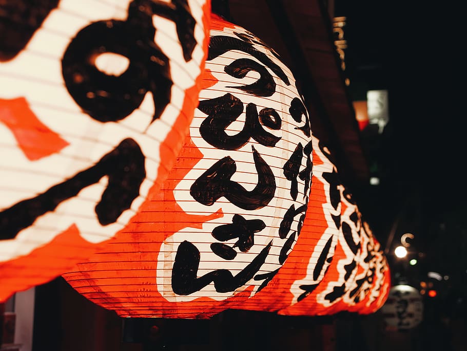 turned-on orange and white hanging Chinese lanterns during nighttime