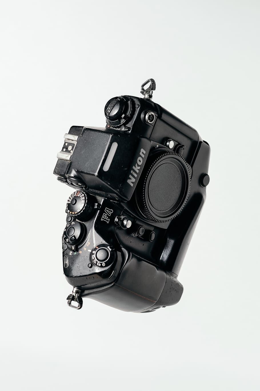 black Nikon DSLR camera on whit surface, studio shot, technology