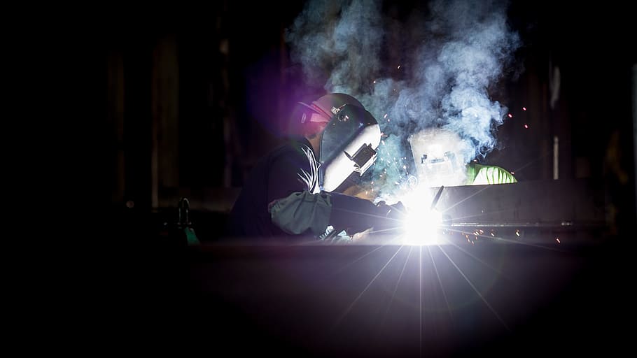 people, helmet, dark, night, welding, blacksmith, light, smoke HD wallpaper