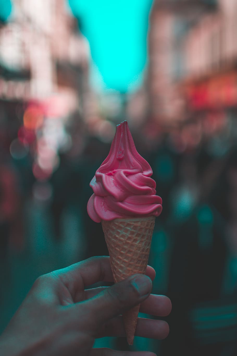 Person Holding Strawberry Ice Cream, blurred background, colors
