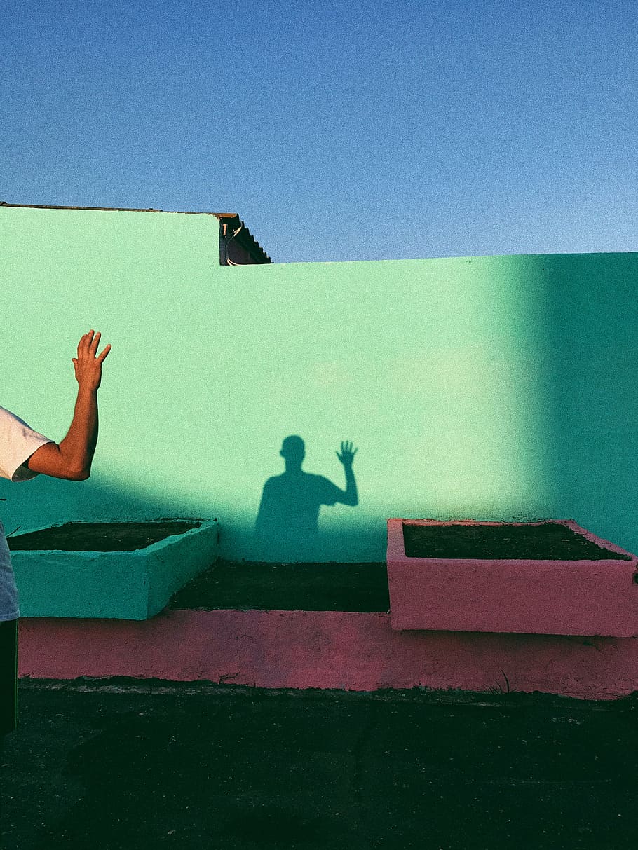 person waving reflecting shadow on teal wall paint, hi, hello HD wallpaper