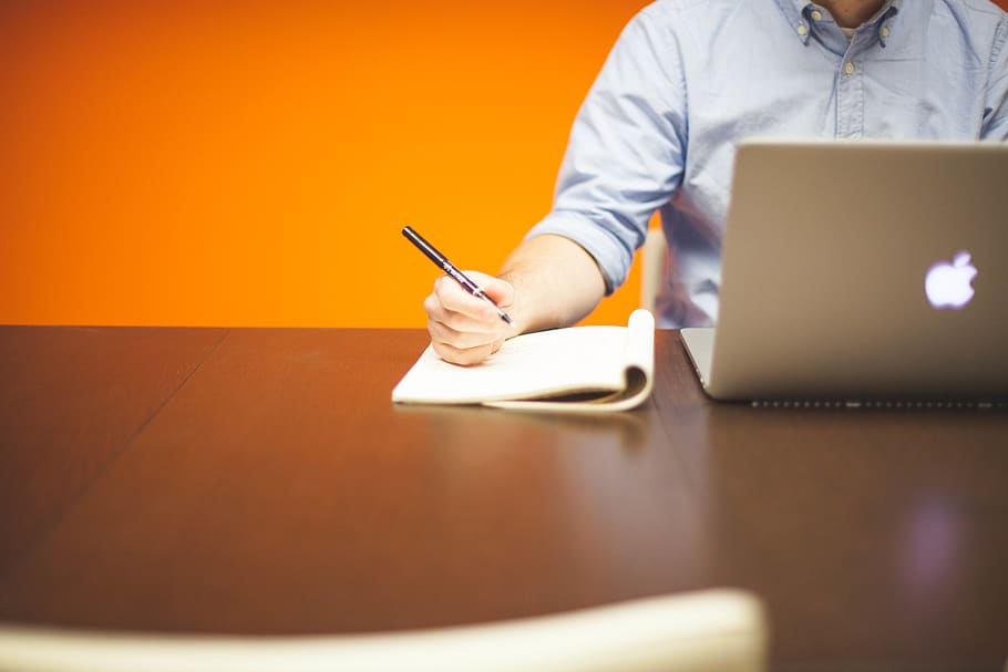 Man Using Macbook While Holding Pen, apple, desk, macbook pro HD wallpaper