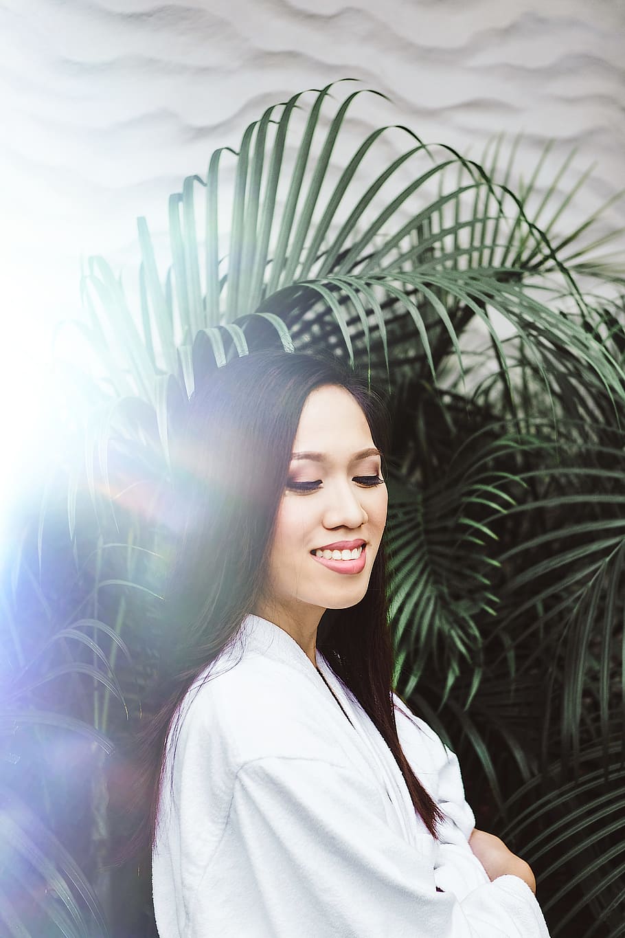 woman standing under fern plant, debut, happy, smile, white, rainbow