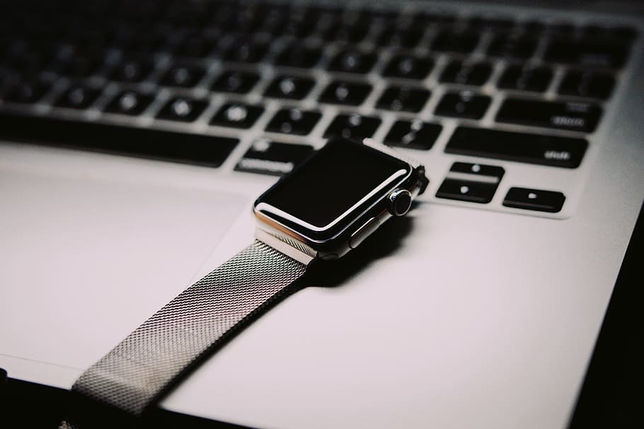 space gray Apple watch with silver mesh band, computer keyboard