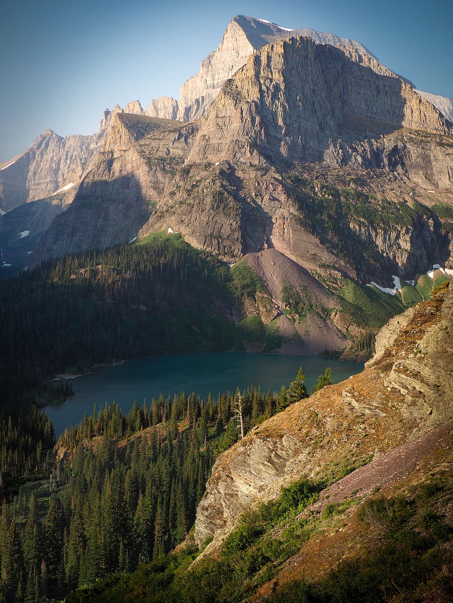 green trees beside mountains at daytime, lake, forest, jagged HD wallpaper