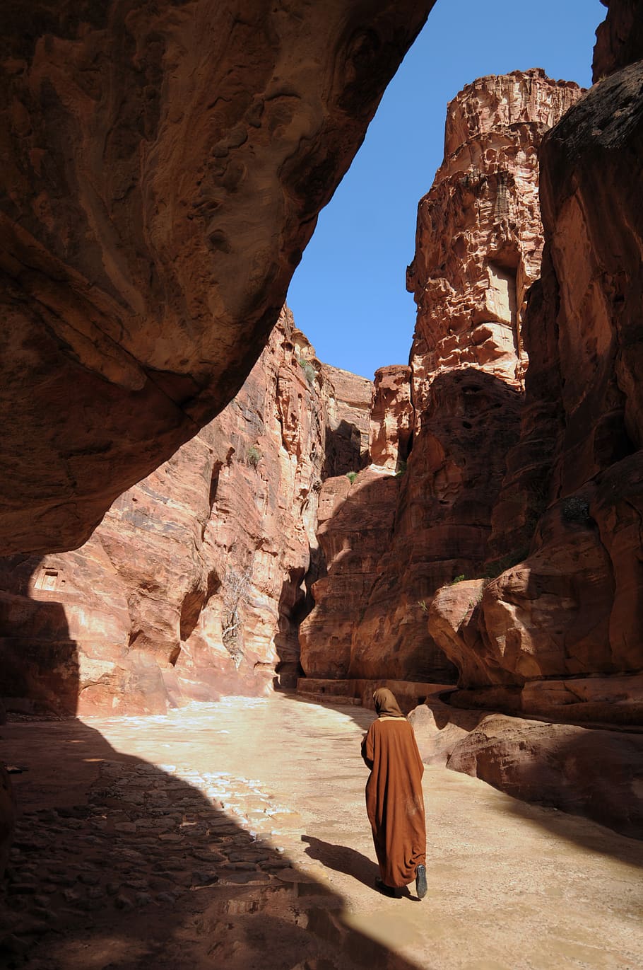 person walking between rocks, rock formation, rock - object, solid HD wallpaper