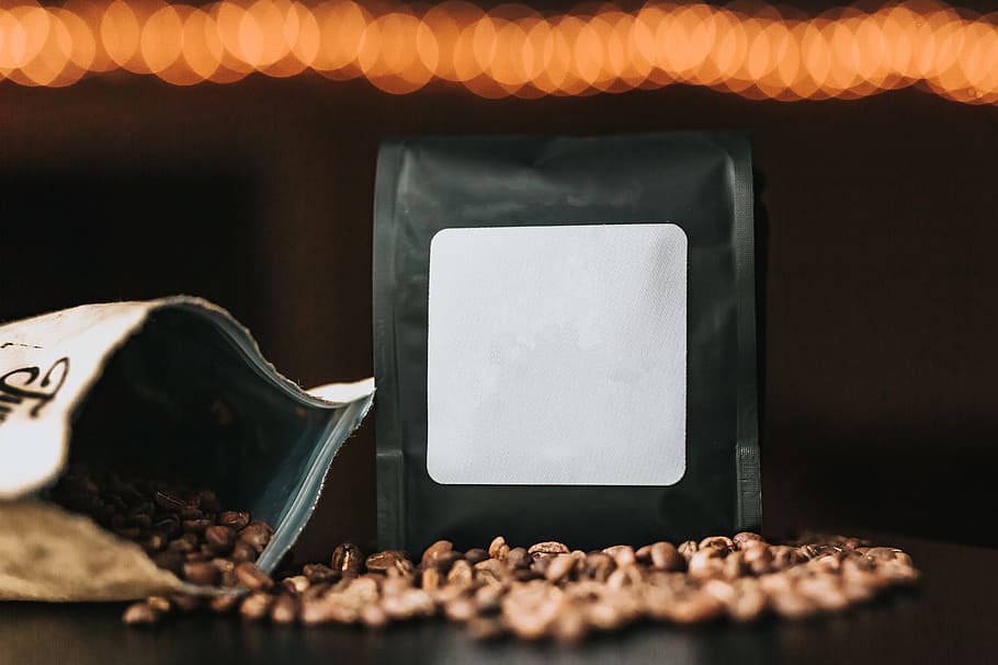 black pack beside coffee bean on desk, bag, pour, bokeh, blur