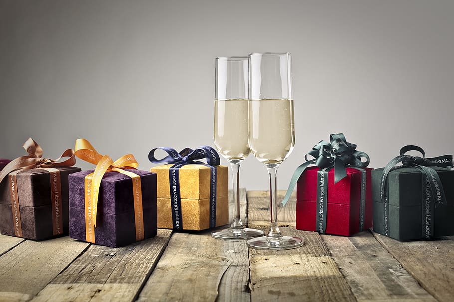 Five Assorted-color Gift Boxes and Two Footed Glasses on Top of Table HD wallpaper