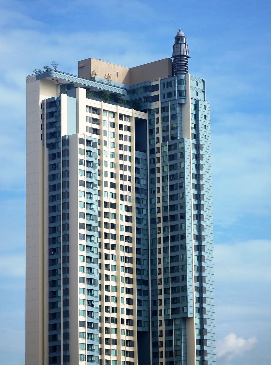Generic high-rise condominium building against a blue sky background - Editorial use only