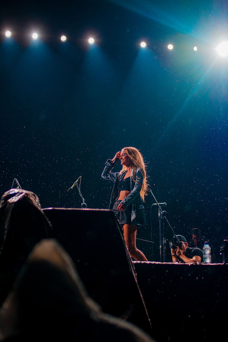 woman-in-blue-top-standing-on-stage.jpg