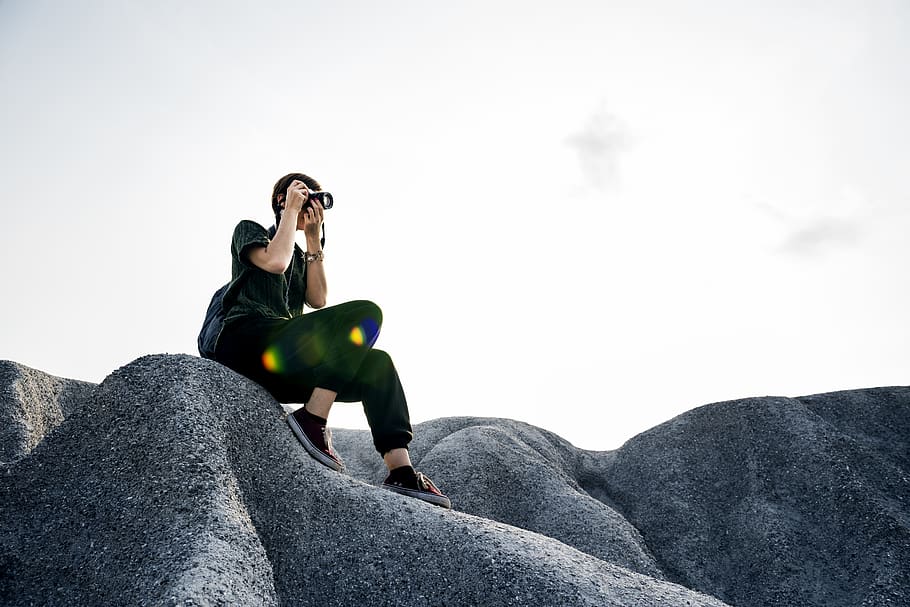 Woman Sitting on Rock Formation, backpack, camera, casual, hobby HD wallpaper