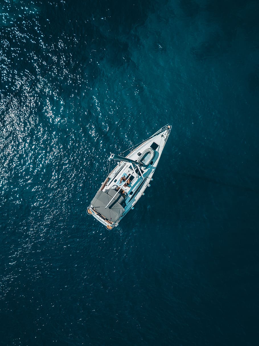 High Angle Photo of White Boat on Body of Water, aerial shot