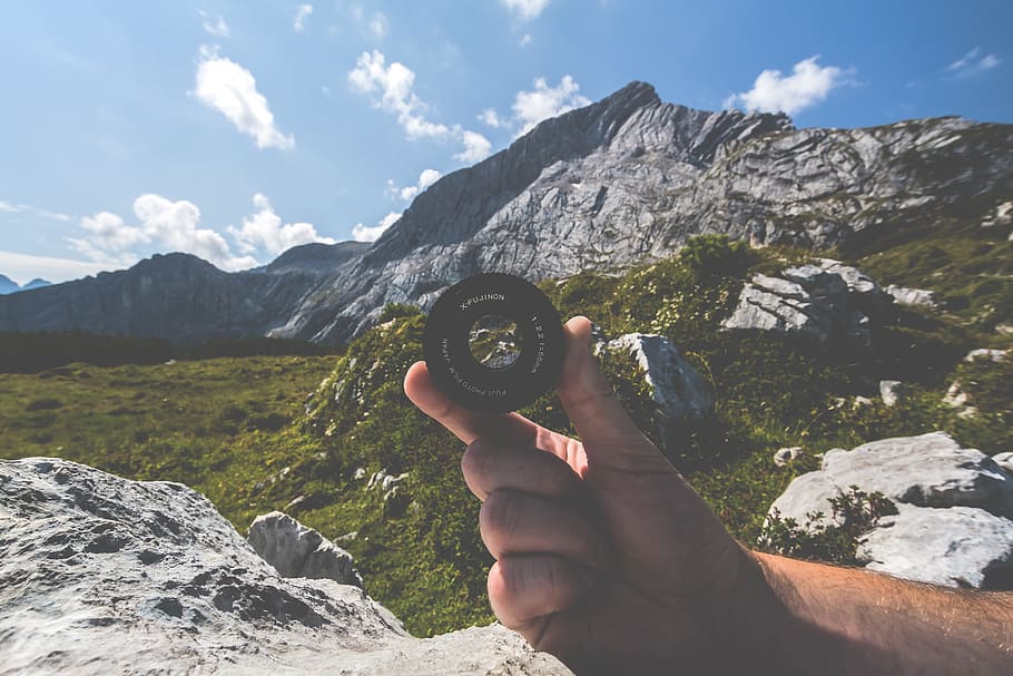 Person Holding Black Camera Lens Near Mountain, adventure, climb HD wallpaper