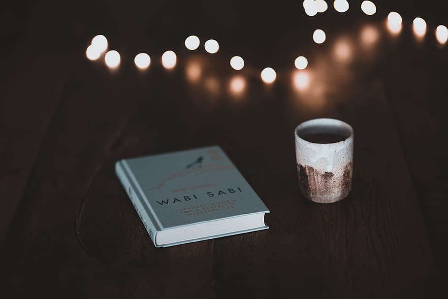 book beside mug, cup, table, light, reading, learn, study, beaker HD wallpaper