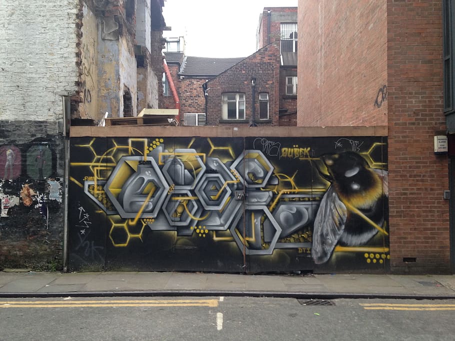 Bee and honeycomb artwork on site hoardings, Tib Street, Manchester.