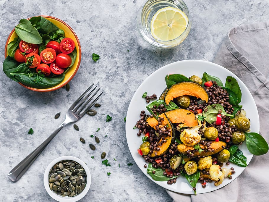 brussels sprout salad and red tomatoes with fork on table, granite countertop HD wallpaper