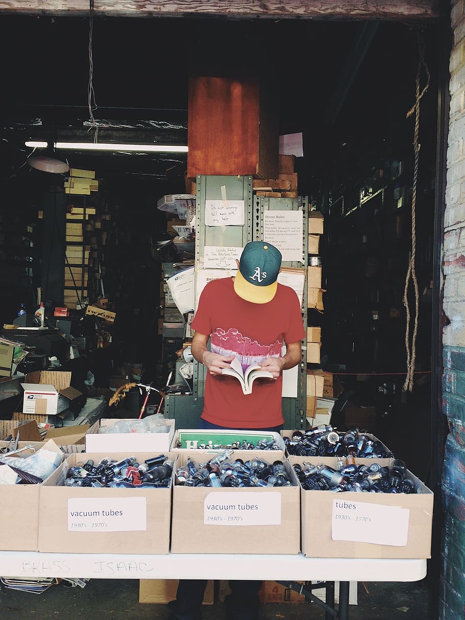 man standing beside boxes, plant, person, human, williamsburg HD wallpaper