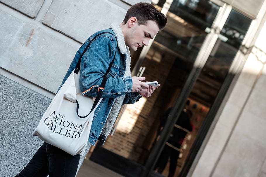 walking man using smartphone, person, human, bag, pants, clothing HD wallpaper