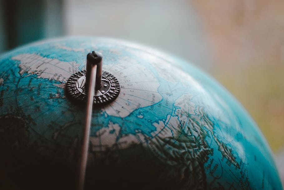 close-up photo of desk globe, earth, map, north pole, closeup