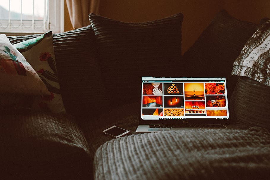 Turned-on Macbook Pro on Sofa, cellphone, clean, close-up, colors HD wallpaper