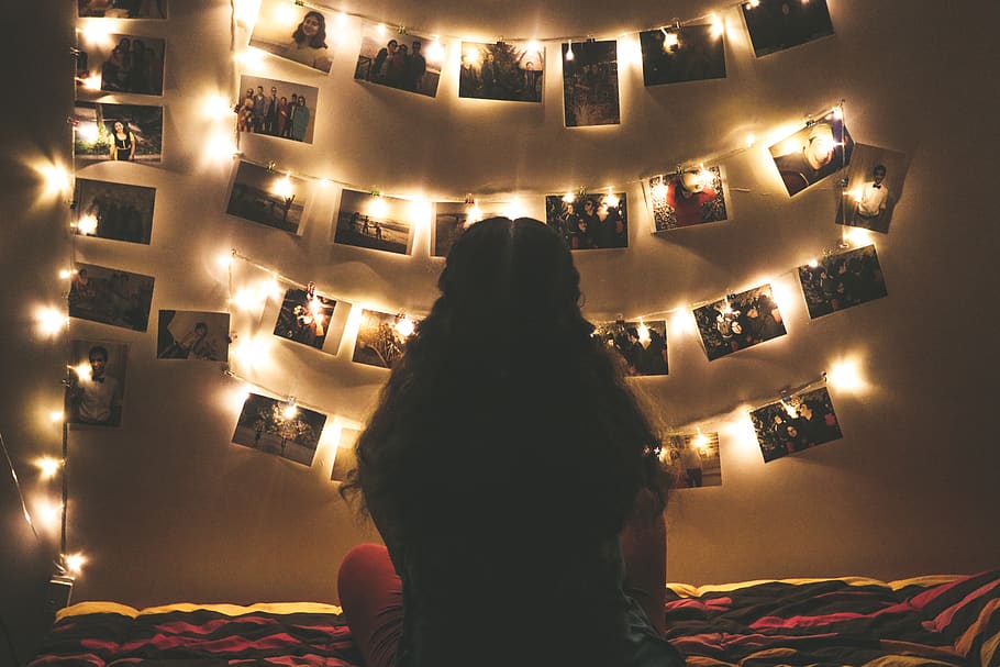 Woman Watching Photo Collection With String Lights, back view HD wallpaper