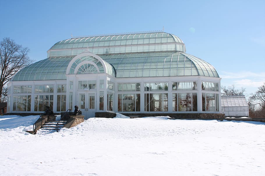 Snow covers the ground around the orchid greenhouse in winter at Duke Farms New Jersey.