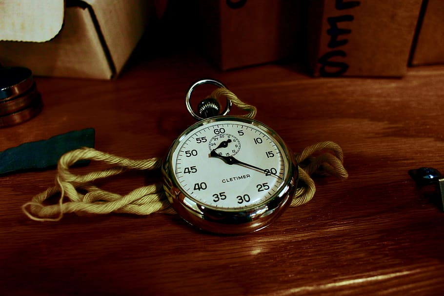 White Pocket Watch With Gold-colored Frame on Brown Wooden Board HD wallpaper
