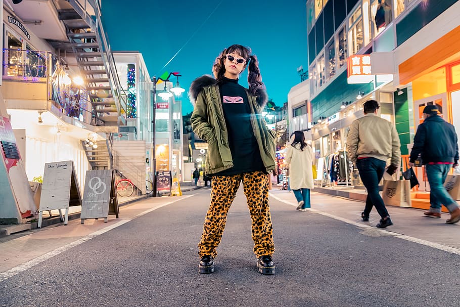 woman in green jacket stands and pose on street, human, person