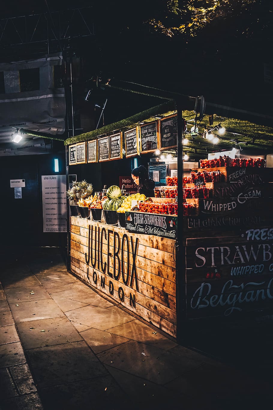 brown wooden fruit stand during nighttime, united kingdom, london