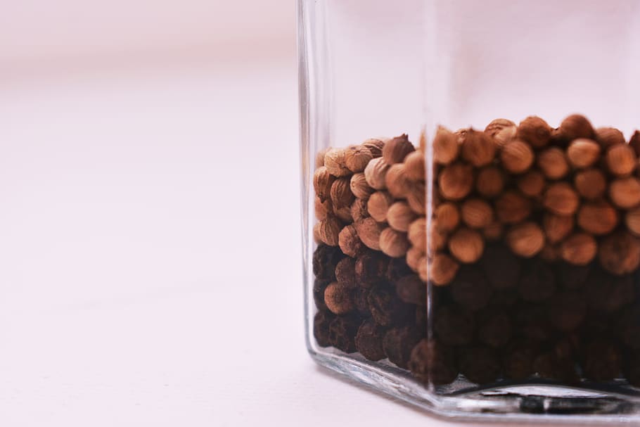 Selective Focus Photography of Peppercorns Inside Glass Container on White Surface HD wallpaper