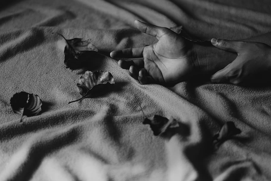 Grayscale Photography of Person's Hands on Textile With Leaves HD wallpaper