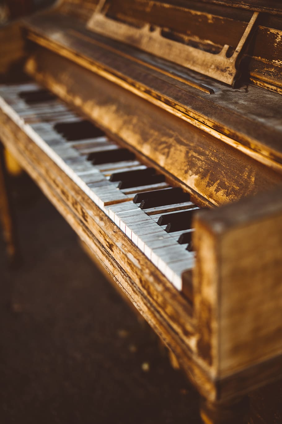 selective focus photogrpahy of brown wooden console piano, keys