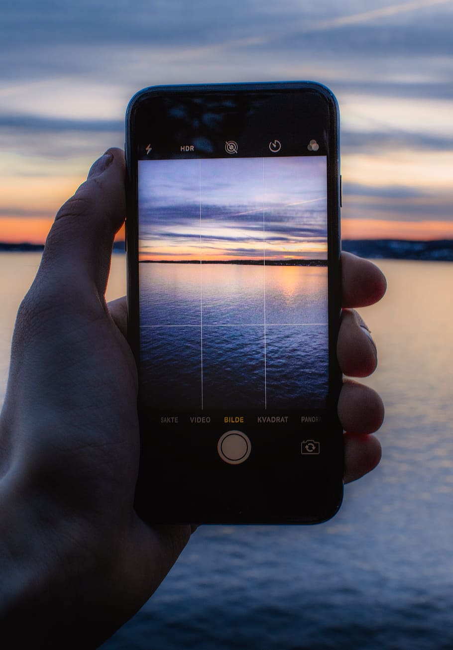 Person Holding Post-2014 Iphone Taking a Photo of Body of Water HD wallpaper