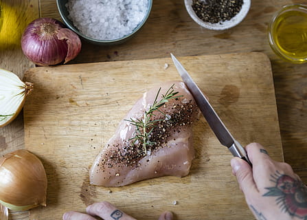 Person Slicing Raw Meat With Pepper on Chopping Board Beside Spices HD wallpaper