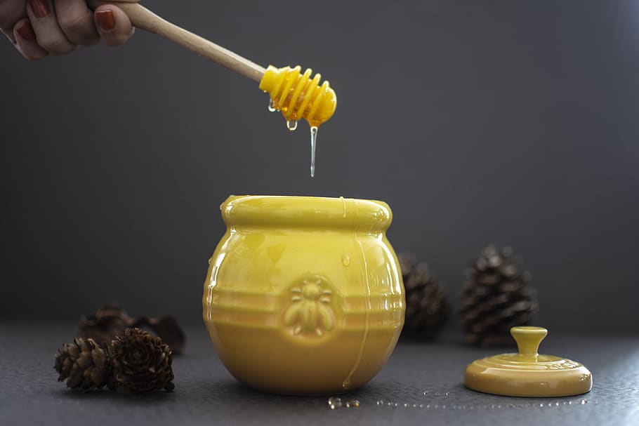 opened yellow ceramic jar beside pine cones, indoors, food and drink HD wallpaper