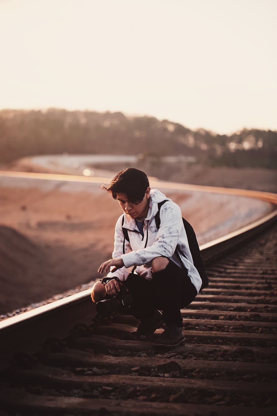 man sitting on train rail, transportation, train track, railway HD wallpaper
