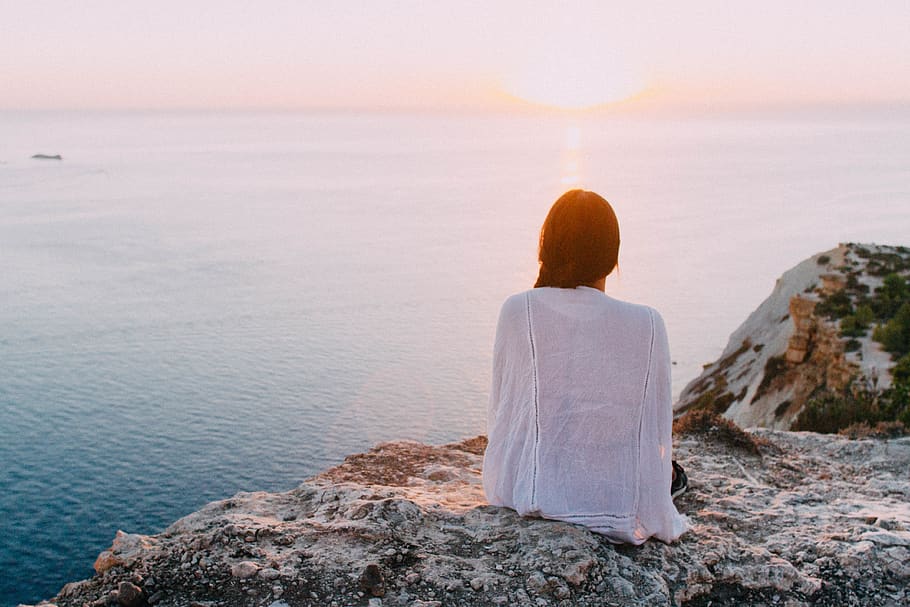 Woman Sitting on Gray Rock Near Body of Water, adventure, back view HD wallpaper