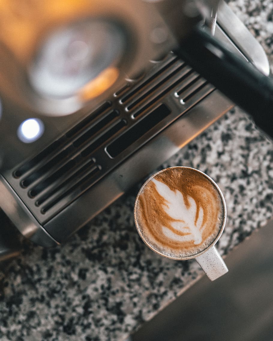 cappuccino in white mug near gray coffee maker, coffee cup, drink, HD wallpaper