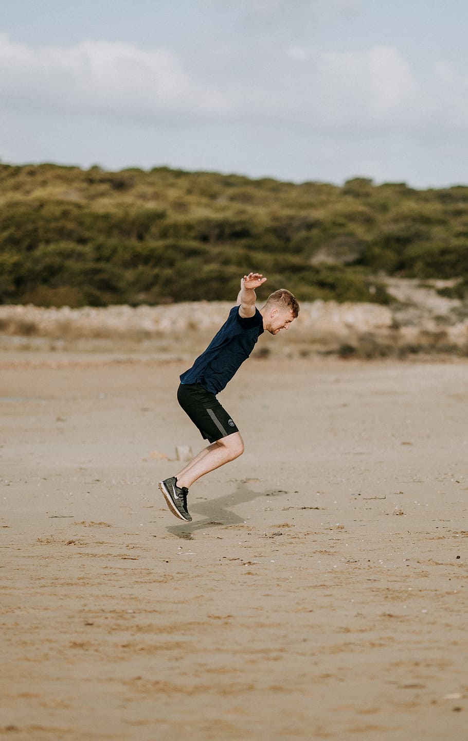 man jumping on sand at daytime, spin, male, motivation, strength HD wallpaper