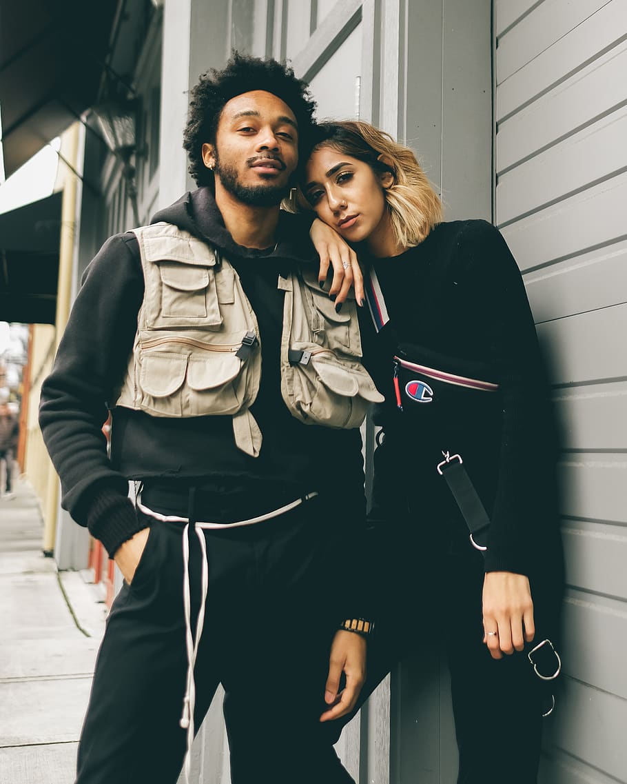 selective focus photography of couple standing beside house, human