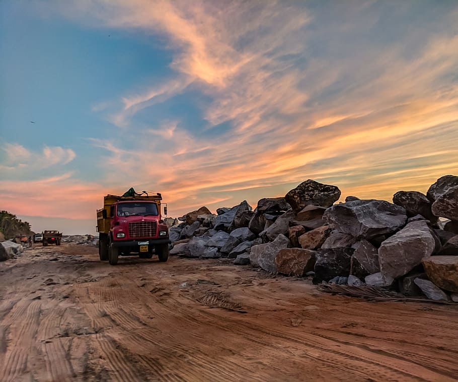 Red Dump Truck Near Filed Rocks Under Cloudy Sky, dawn, dusk HD wallpaper