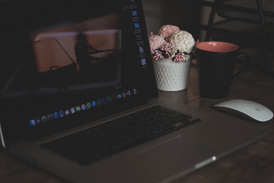 Turned on Macbook Pro, artificial flowers, close-up, coffee cup HD wallpaper