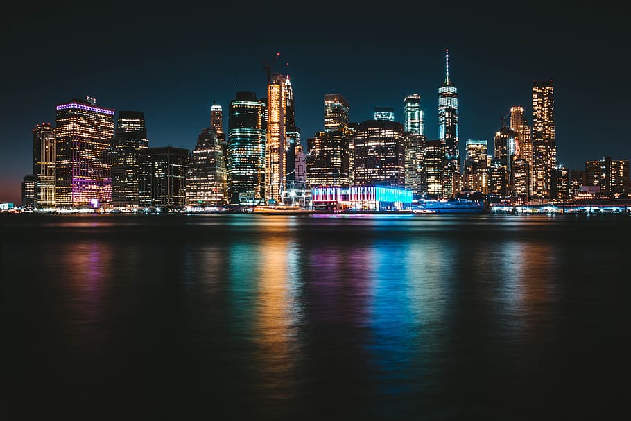 city with lights turned-on during nighttime, building, water HD wallpaper