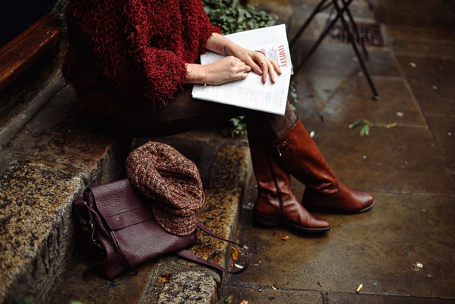 Woman Sitting While Holding Book, bag, boots, cap, fashion, footwear HD wallpaper